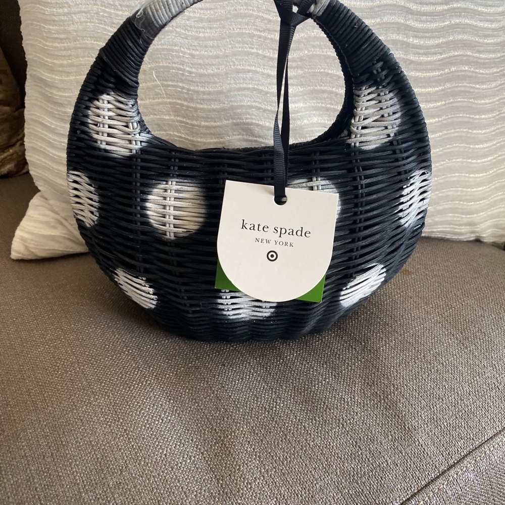 Kate Spade Black and White Woven Bag in hand